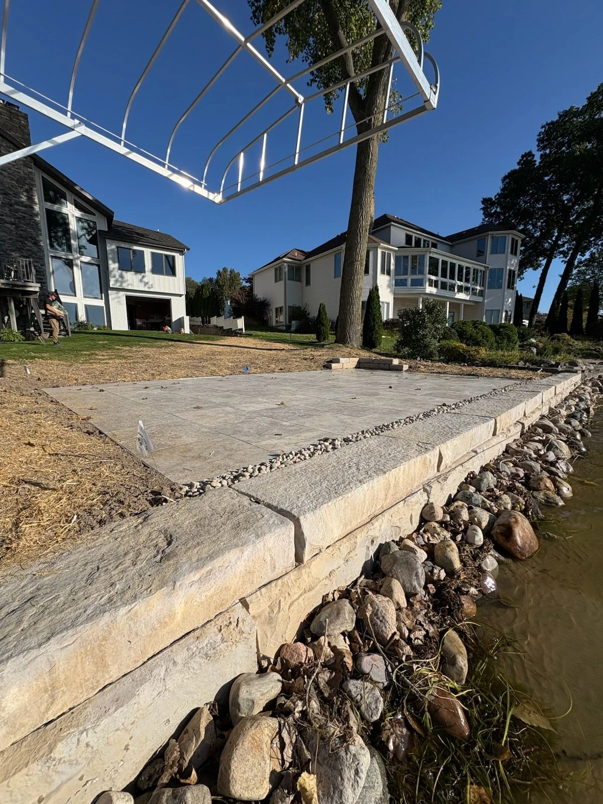 Professional hardscape patio installation with pavers and retaining walls