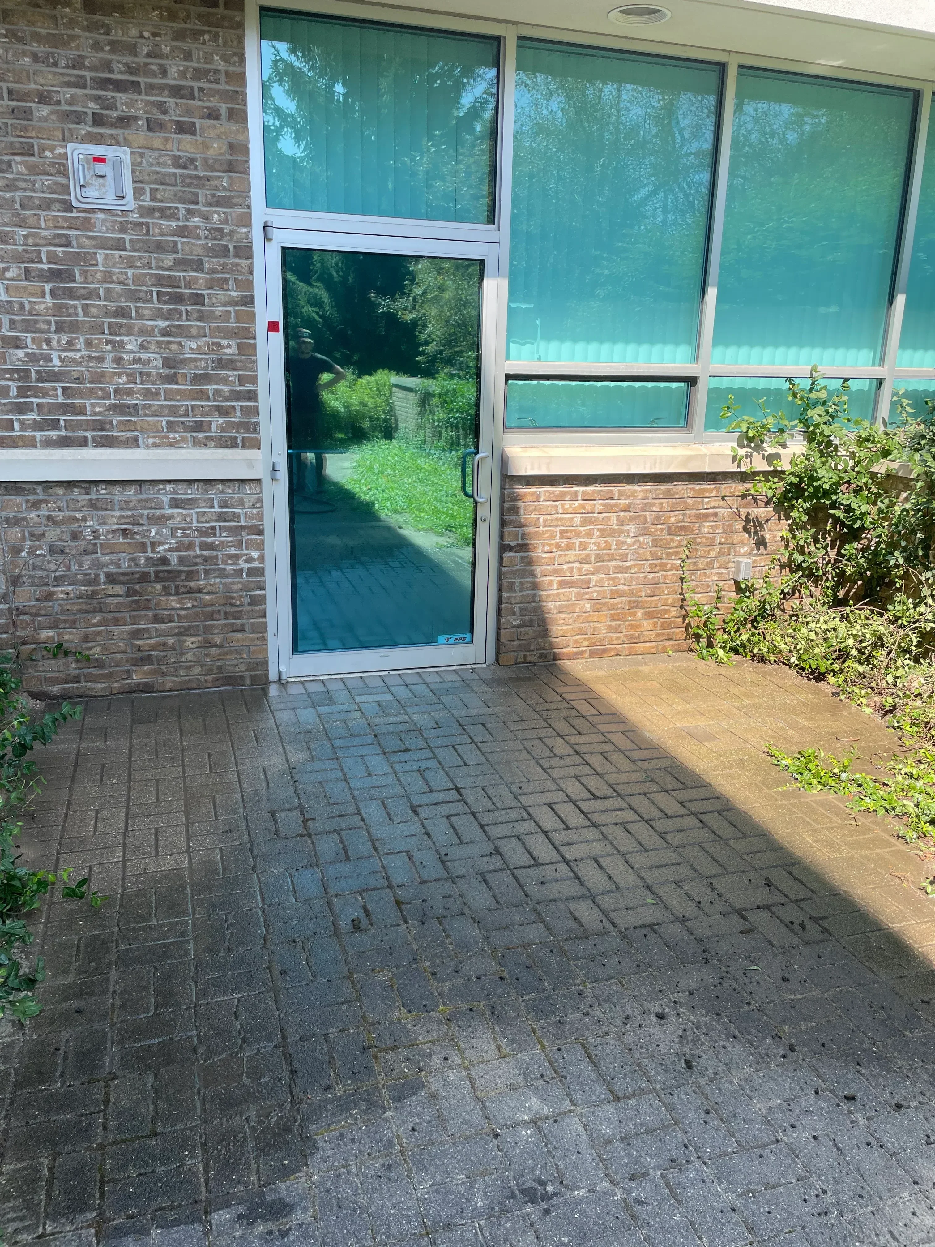 Cleaned brick patio with pressure-washed concrete block wall and restored mortar joints