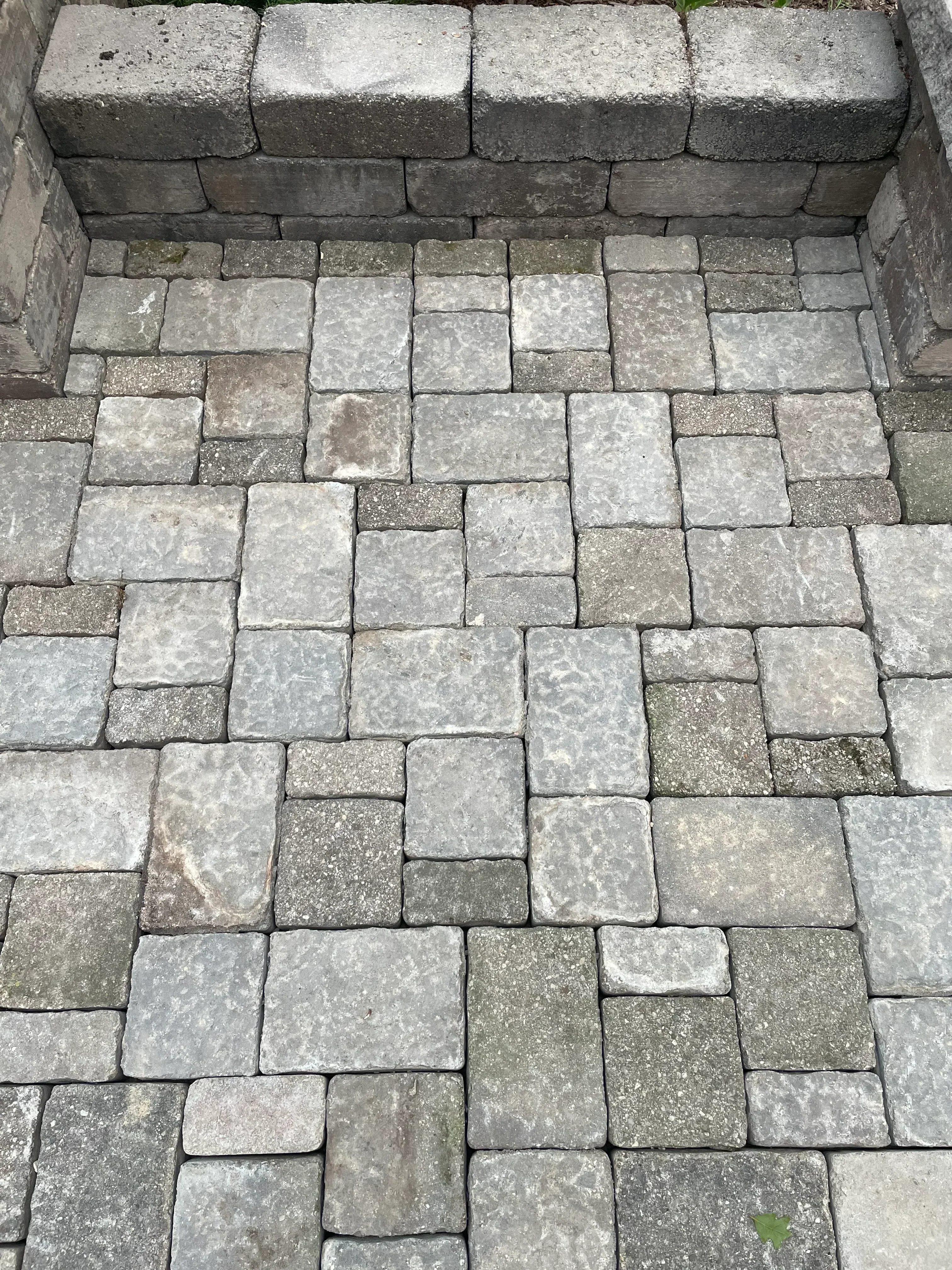 Random ashlar permeable paver patio with gray and tan concrete pavers and clean grout joints